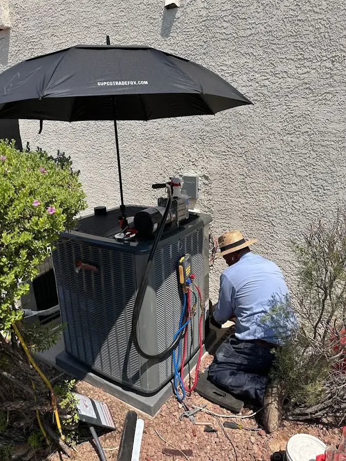 HVAC technician performing outdoor AC maintenance in Langley Park